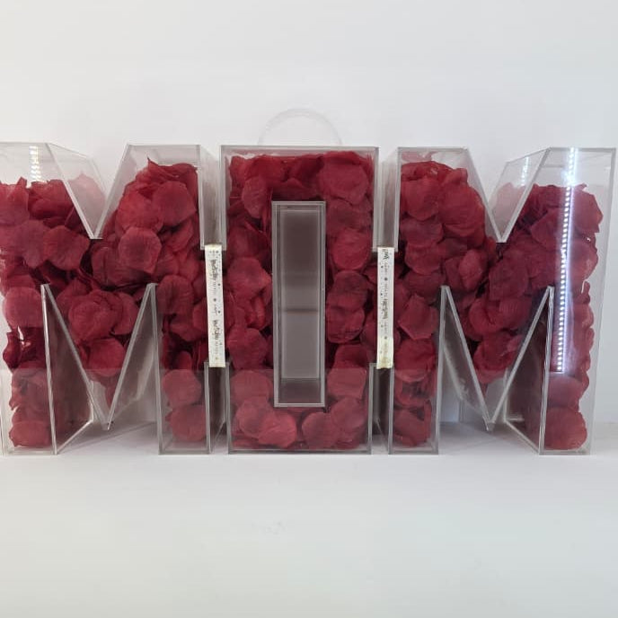 Decorative letters spelling 'MOM' filled with red flowers on a white background